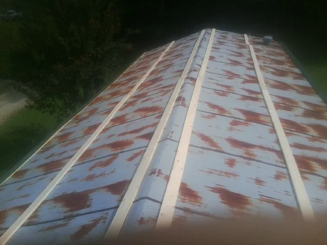 Rusted metal roof panels with new wood purlins before replacement — Storm Damage Roof Repair in Port Trevorton by Roofing Brothers