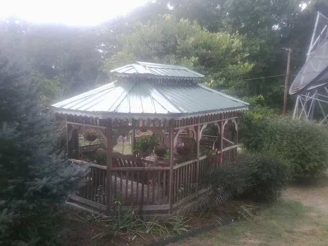 Green metal roof on a backyard gazebo surrounded by garden beds in Port Trevorton