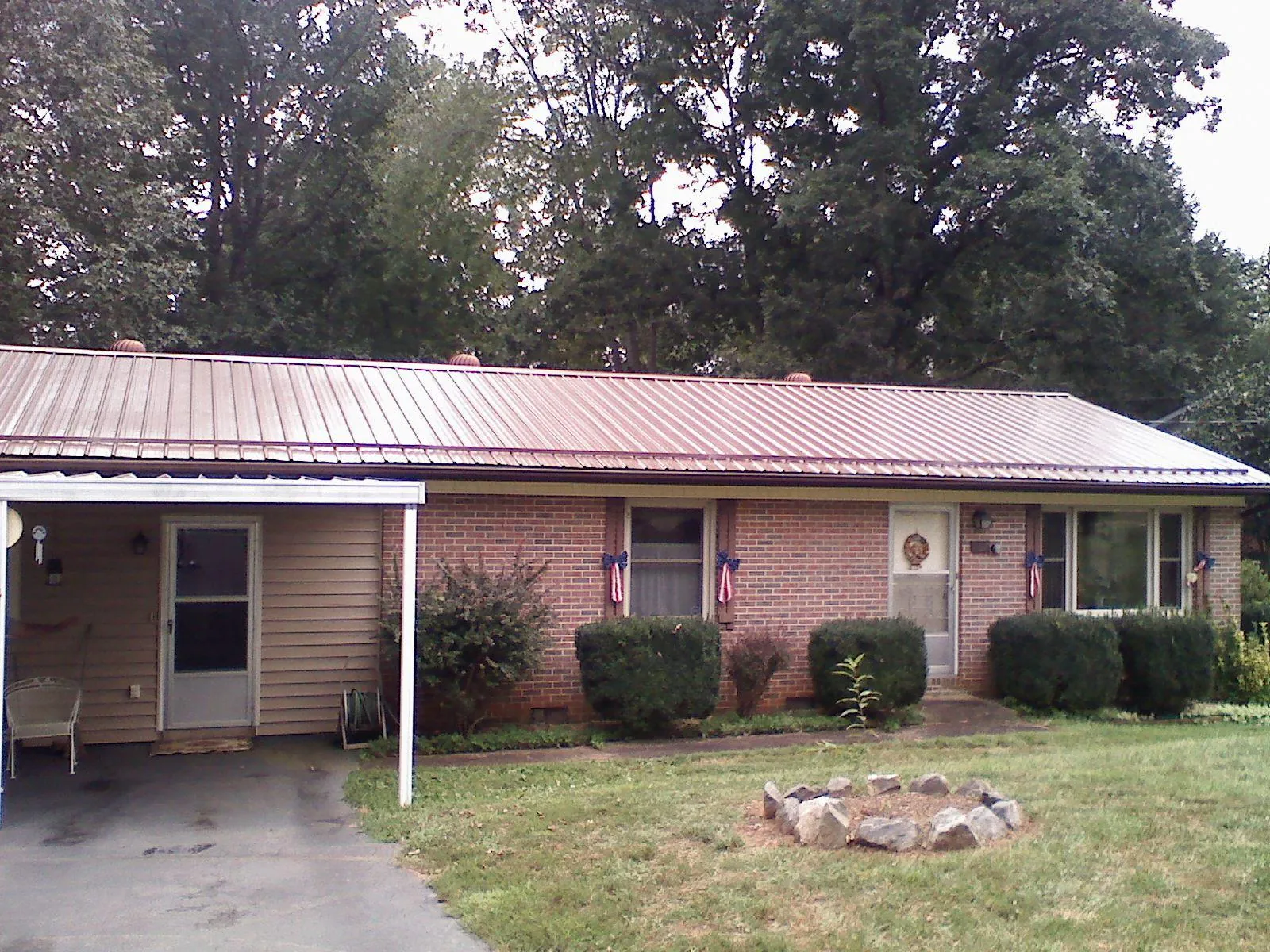 Bronze metal roof and carport on a brick ranch home — Roof Repair work by our crew in Port Trevorton